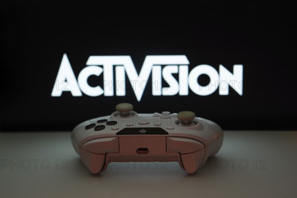 Dhaka, Bangladesh- 23 Sep 2025: A close-up of a white gamepad with the Activision seen on screen in