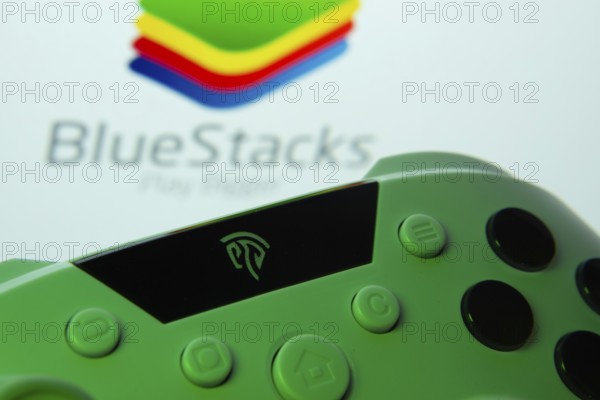 Dhaka, Bangladesh- 23 Sep 2025: A close-up of a gamepad with the BlueStacks seen on screen in the
