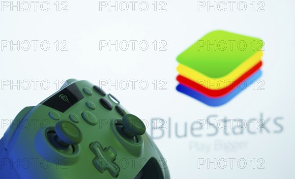 Dhaka, Bangladesh- 23 Sep 2025: A close-up of a gamepad with the BlueStacks seen on screen in the
