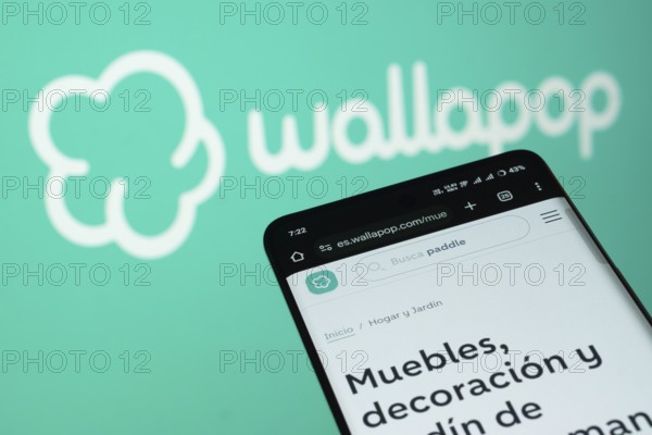 Dhaka, Bangladesh- 03 July 2025: Smartphone displaying Wallapop web interface against wallapop logo