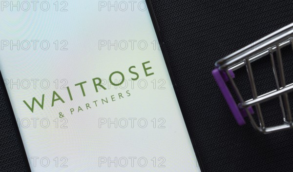 Dhaka, Bangladesh- 03 July 2025: A smartphone displaying the Waitrose & Partners logo next to a