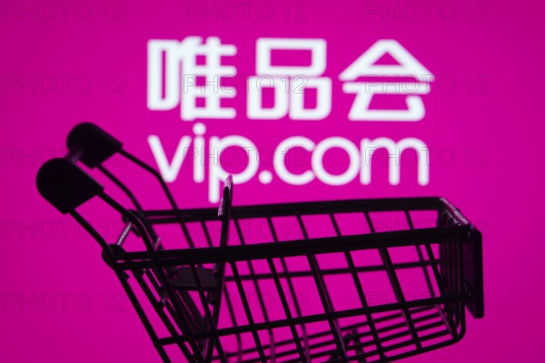 Dhaka, Bangladesh- 03 July 2025: Silhouette of a shopping cart in front of the Vip.com logo,