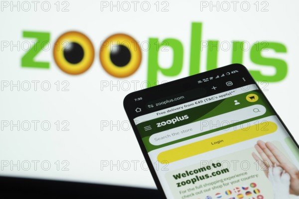 Dhaka, Bangladesh- 03 July 2025: Smartphone displaying zooplus web interface against Zooplus logo