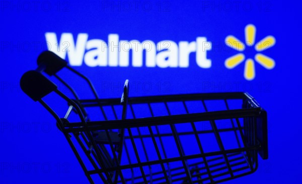 Dhaka, Bangladesh- 03 July 2025: Silhouette of a shopping cart in front of the Walmart logo,
