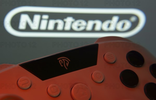 Dhaka, Bangladesh- 15 July 2025: A close-up of a gamepad with the nintendo seen on screen in the