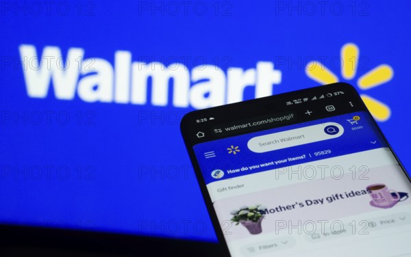Dhaka, Bangladesh- 03 July 2025: Smartphone displaying Walmart web interface against Walmart logo