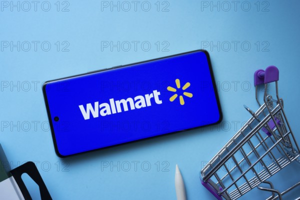 Dhaka, Bangladesh- 03 July 2025: Smartphone displaying Walmart logo with shopping cart on a blue