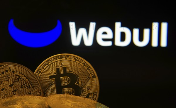 Dhaka, Bangladesh- 04 April 2025: Close-up of Bitcoin coins with the webull logo visible on a