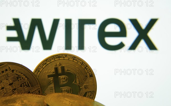 Dhaka, Bangladesh- 27 July 2025: Close-up of Bitcoin coins with the wirex logo visible on a screen