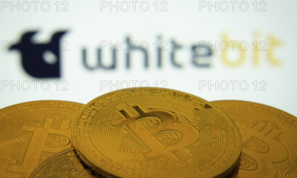Dhaka, Bangladesh- 03 Sep 2025: Close-up of Bitcoin coins with the whitebit logo visible on a