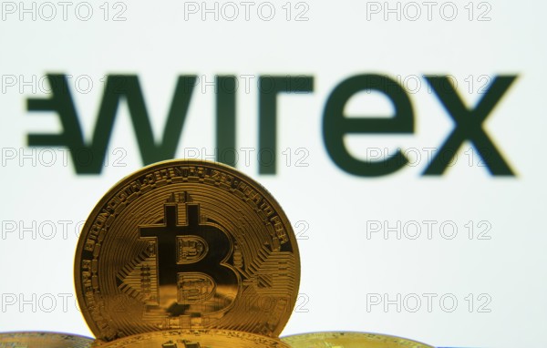 Dhaka, Bangladesh- 04 April 2025: Close-up of Bitcoin coins with the wirex logo visible on a screen