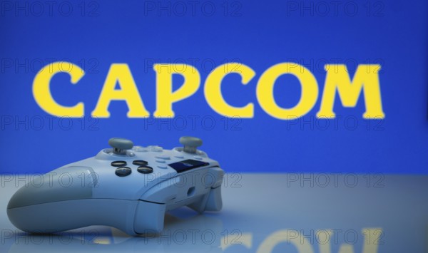 Dhaka, Bangladesh- 19 Sep 2025: A close-up of a white gamepad with the Capcom seen on screen in the