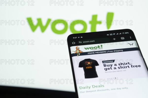 Dhaka, Bangladesh- 03 July 2025: Smartphone displaying Woot web interface against woot logo