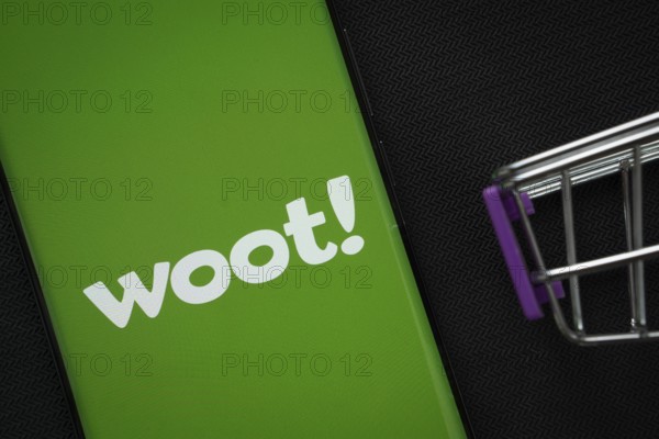 Dhaka, Bangladesh- 03 July 2025: A smartphone displaying the Woot logo next to a miniature shopping