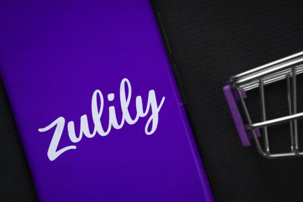 Dhaka, Bangladesh- 03 July 2025: A smartphone displaying the Zulily logo next to a miniature