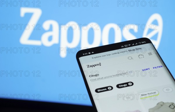 Dhaka, Bangladesh- 03 July 2025: Smartphone displaying Zappos web interface against Zappos logo