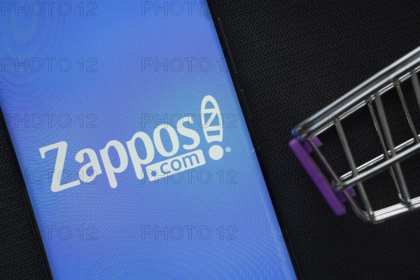 Dhaka, Bangladesh- 03 July 2025: A smartphone displaying the Zappos logo next to a miniature