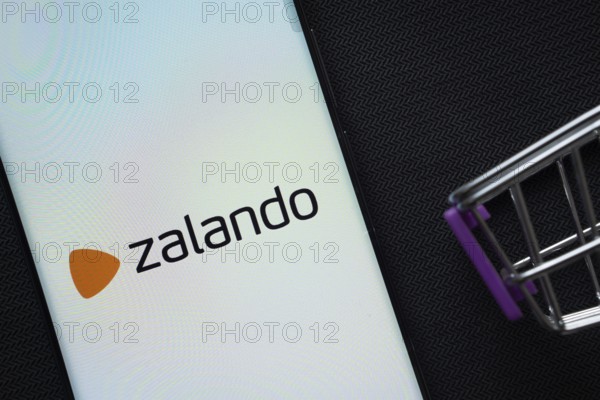 Dhaka, Bangladesh- 03 July 2025: A smartphone displaying the Zalando logo next to a miniature