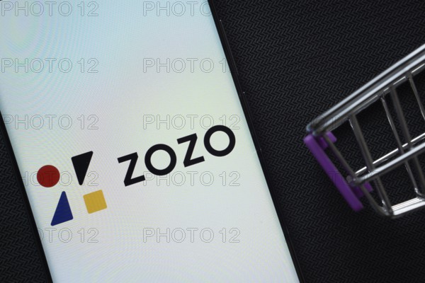 Dhaka, Bangladesh- 03 July 2025: A smartphone displaying the ZOZO logo next to a miniature shopping