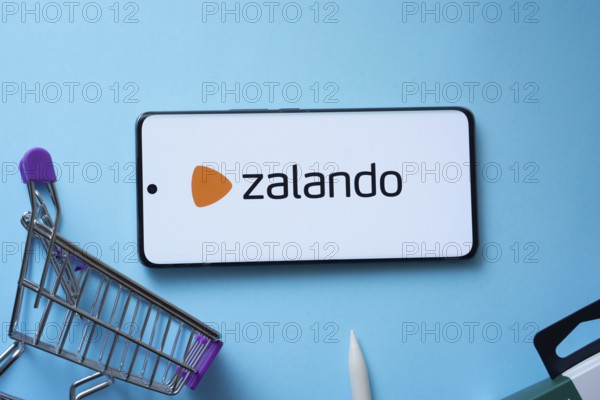 Dhaka, Bangladesh- 03 July 2025: Smartphone displaying Zalando logo with shopping cart on a blue