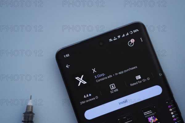 Dhaka, Bangladesh- 29 May 2025: On a blue surface, a smartphone displays the X app within the