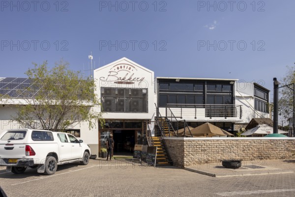 Street view of a modern building with a restaurant or café entrance in Outjo, Namibia 12 Augusto