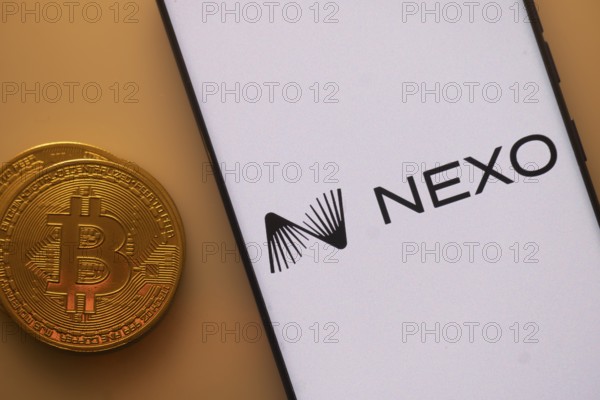 Nexo logo on smartphone screen beside Bitcoin, highlighting financial technology and cryptocurrency