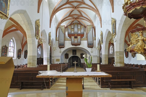 View of the altar and organ from the centre of the church, decorative vaults and artistic design,