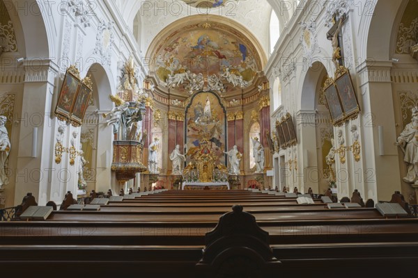 Magnificently designed Baroque church nave with richly decorated altarpieces and magnificent