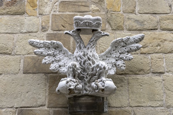 Stone relief of a crowned eagle, symmetrically and artistically embedded in a wall, St.Stephan's
