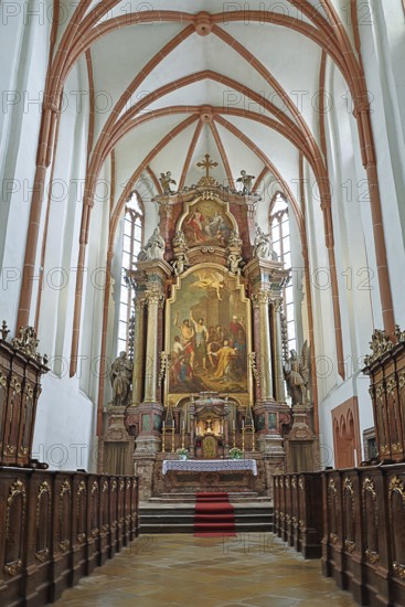 Majestic church altar with detailed woodwork and high ceiling structures, parish church of St