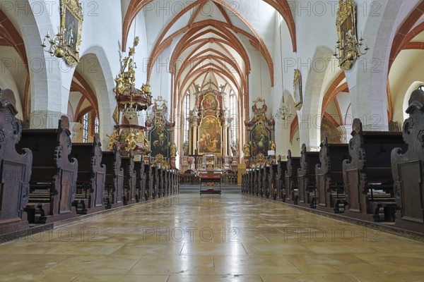 Magnificent church interior with richly decorated ceiling, altar area and ornate sculptures, St