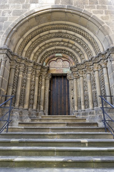 Romanesque stone door, carner with detailed decorations, symmetrically constructed, with stairs,