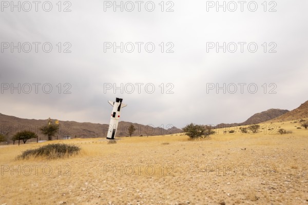 A mock Soviet rocket stands nose-first in the Solitaire, Namibian desert, surrounded by golden