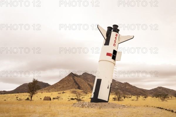 A mock Soviet rocket stands nose-first in the Solitaire, Namibian desert, surrounded by golden