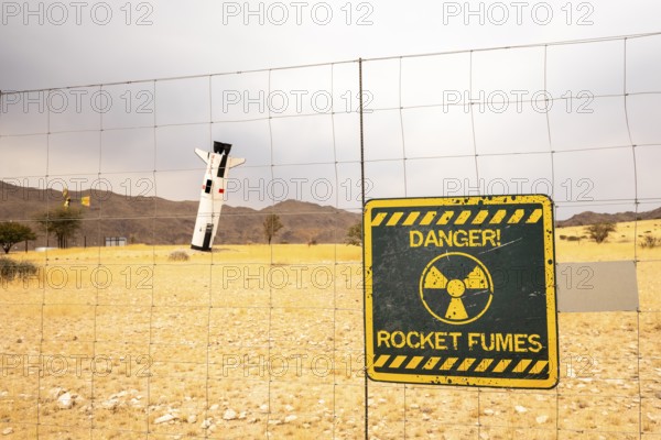 A mock Soviet rocket stands nose-first in the Solitaire, Namibian desert, surrounded by golden