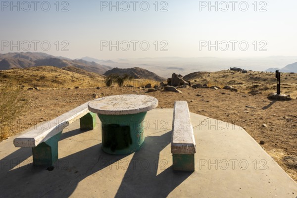 A picnic spot overlooks the vast Namib Desert from Spreetshoogte Pass, with hazy plains, rugged