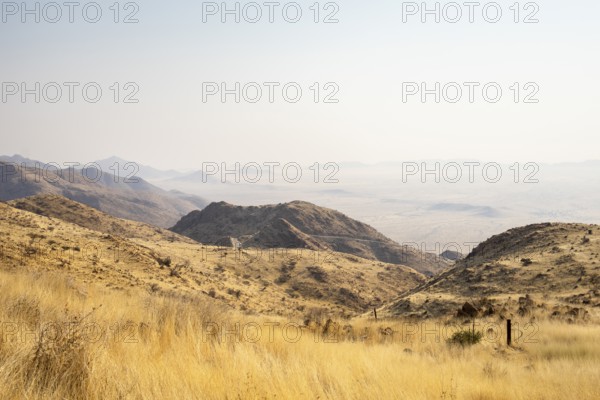 A picnic spot overlooks the vast Namib Desert from Spreetshoogte Pass, with hazy plains, rugged