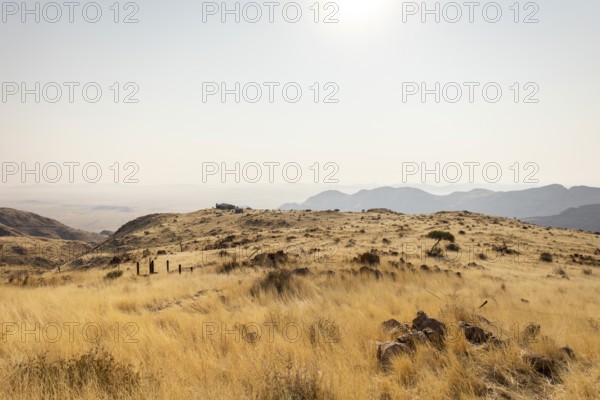 A picnic spot overlooks the vast Namib Desert from Spreetshoogte Pass, with hazy plains, rugged