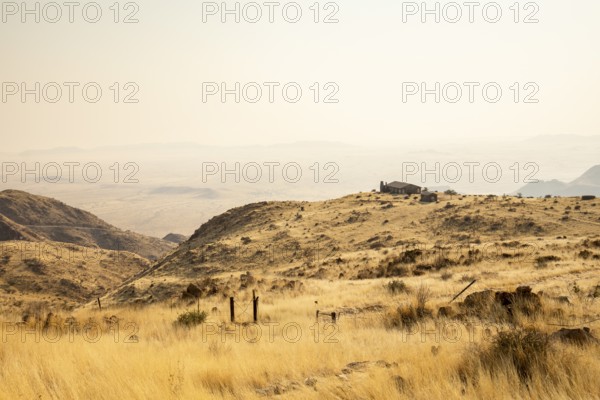 A picnic spot overlooks the vast Namib Desert from Spreetshoogte Pass, with hazy plains, rugged