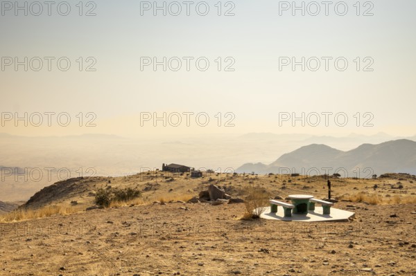 A picnic spot overlooks the vast Namib Desert from Spreetshoogte Pass, with hazy plains, rugged
