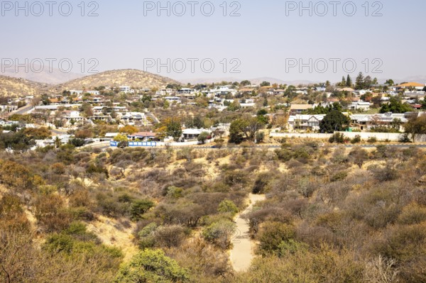 A panoramic view of Windhoek, Namibia, from the National Botanic Garden, showing the city's mix of