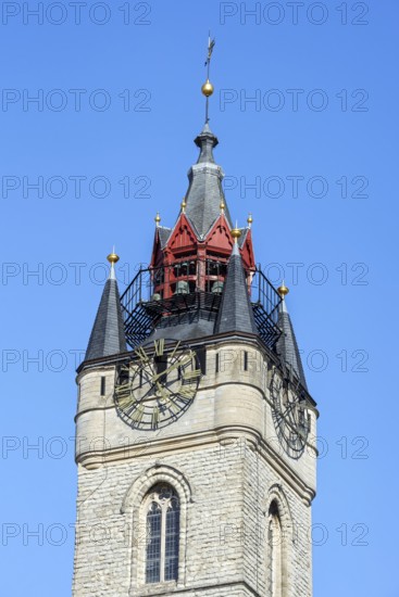 Close-up of 14th century Gothic belfry tower with carillon and clock in the historic city centre of