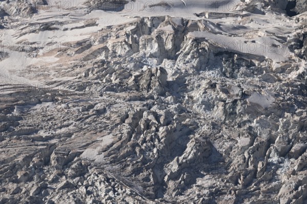 Impressive scene shows lines and textures on residual ice cream in mountains. Daylight emphasises