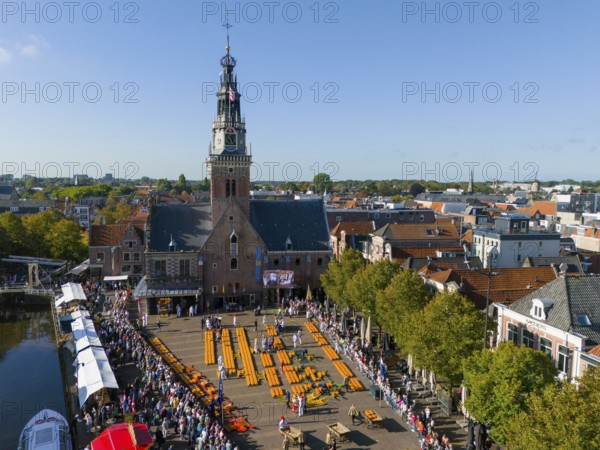 Historic market square with church and crowd under blue sky, aerial view, cheese, cheese market,
