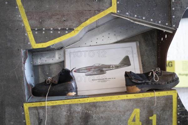 Wooden shoes of a forced labourer standing on an aircraft wing, documentation centre in the old