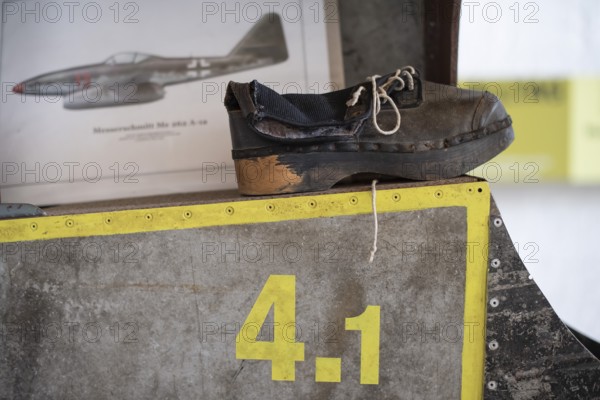 Wooden shoe of a forced labourer stands on aircraft wing, documentation centre in the old Engelberg