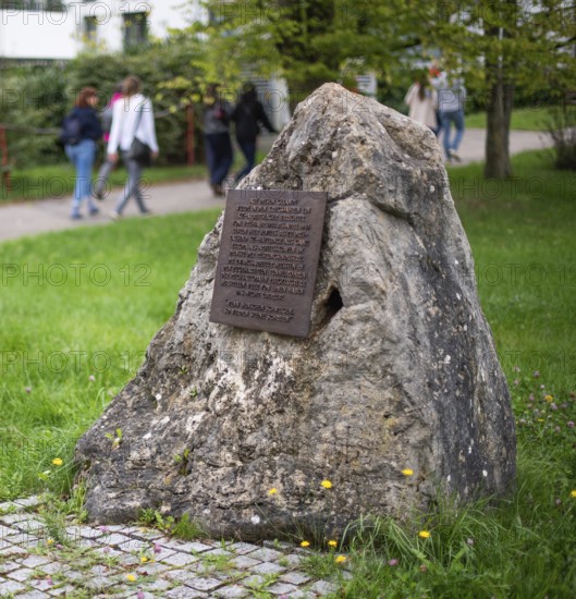 Stone with memorial plaque commemorating forced labourers and prisoners in concentration camp