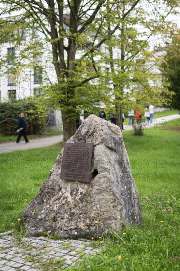 Stone with memorial plaque commemorating forced labourers and prisoners in concentration camp
