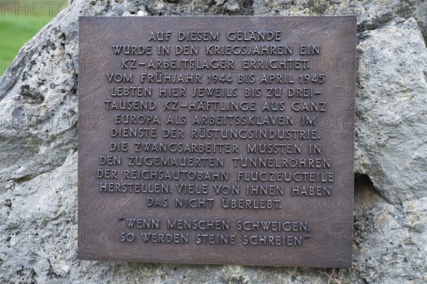 Stone with memorial plaque commemorating forced labourers and prisoners in concentration camp